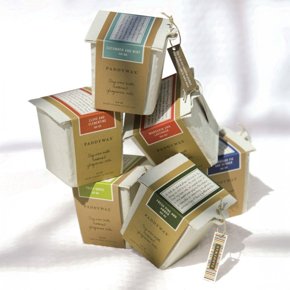 Paddywax's sustainable candle packaging using natural molded pulp with rustic aesthetic