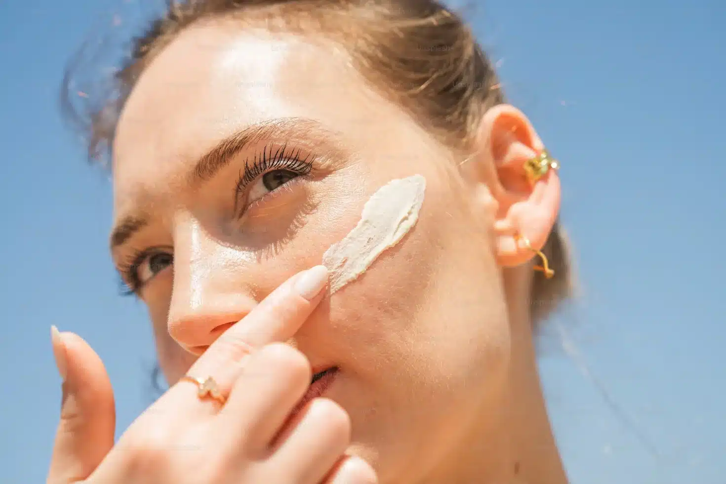 Woman applying sunscreen